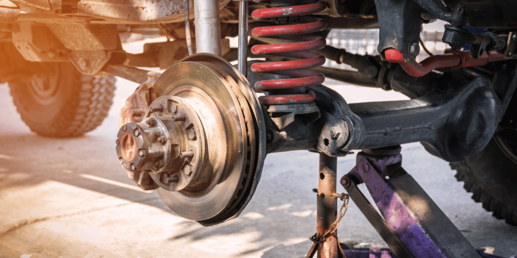 A picture of a car's suspension system, showing the ball joints, control arm bushings, and sway bar links.